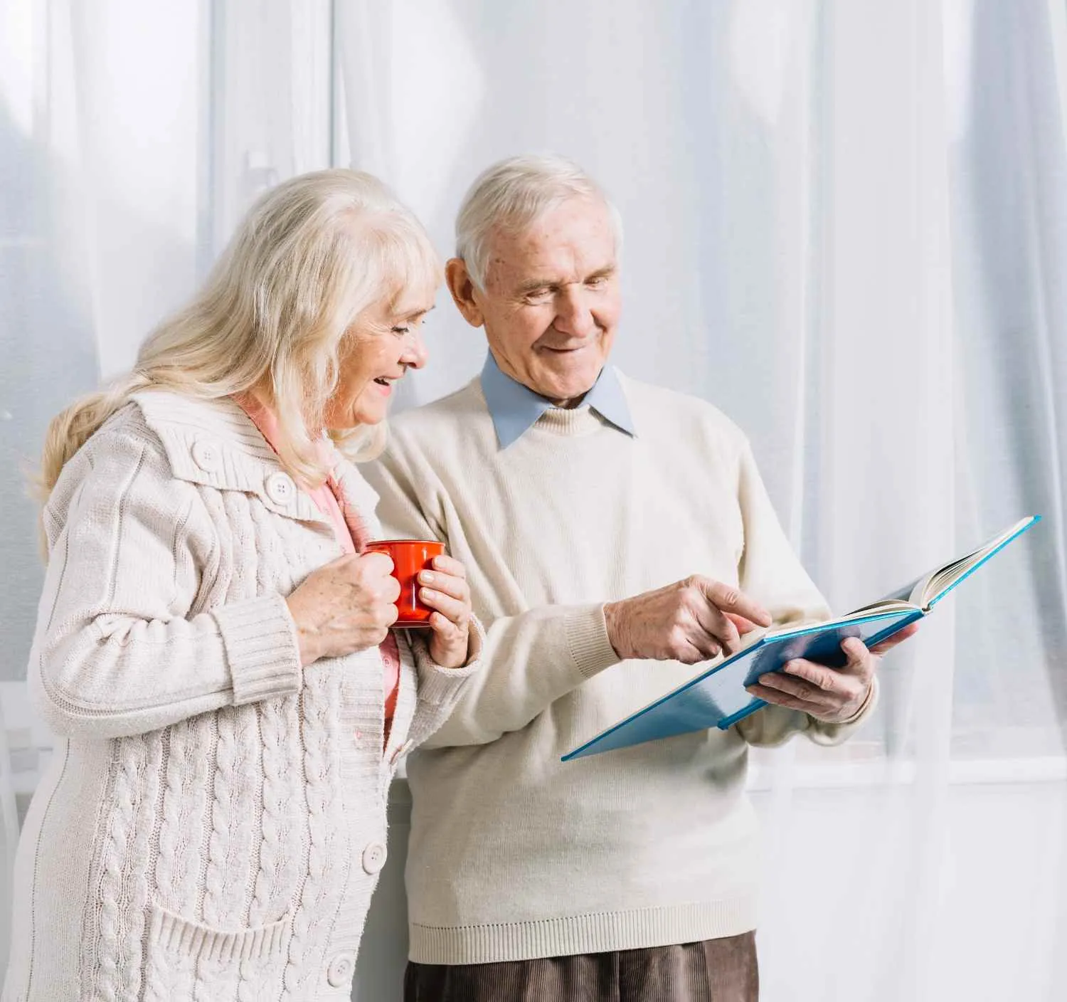 Retired couple looking over their Medicare paperwork together at home